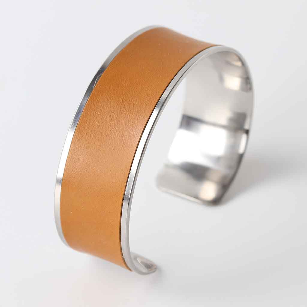 ladies bracelet with leather, silver colour base and tan leather band