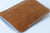 Tan leather sleeve for iPhone 15